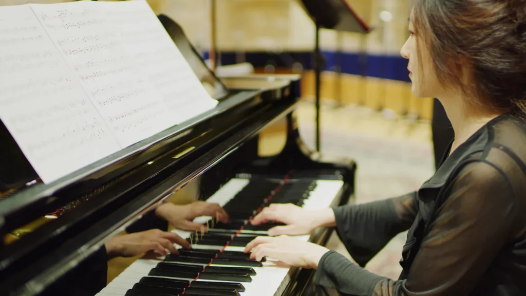 Ellen playing a grand piano