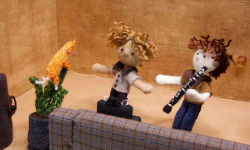 stop-motion image of two musicians inside a music studio with an orange cat