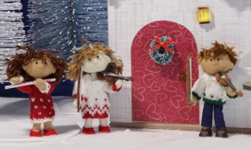 stop-motion image of 3 miniature felt dolls wearing holiday apparel holding their musical instruments
